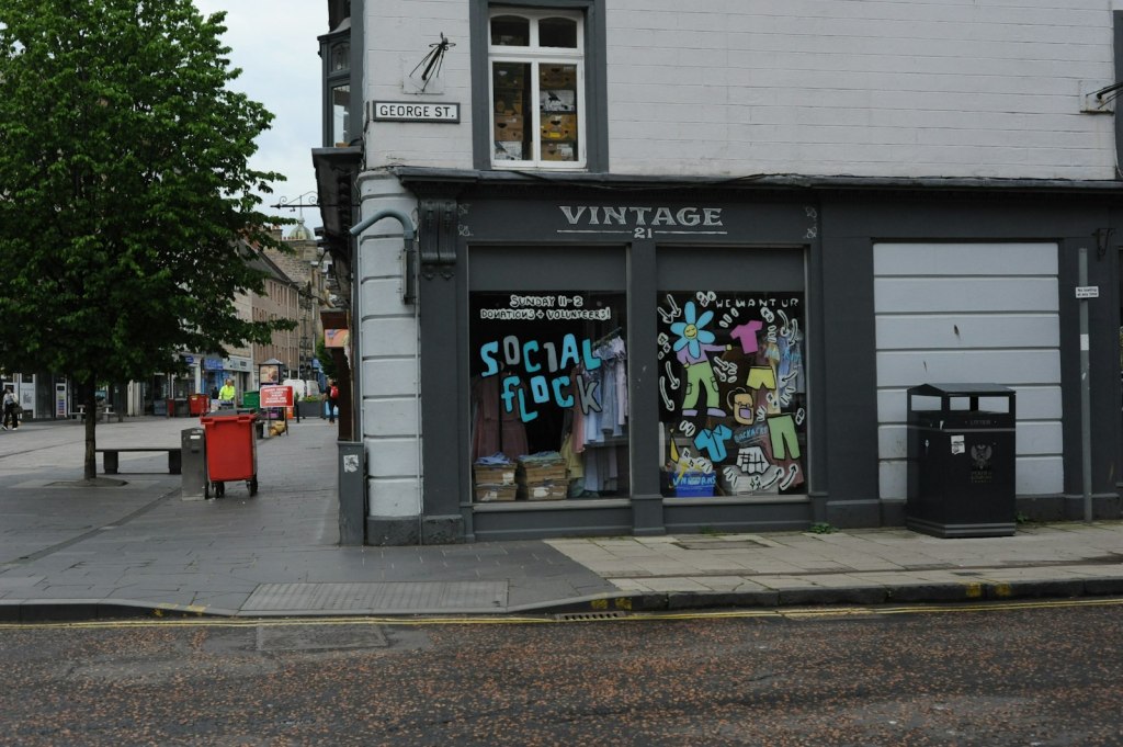 A second-hand shop with a colourful window display on a UK high street